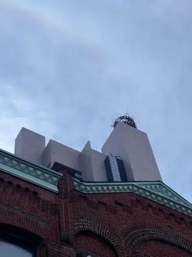 Skyward gaze at historic brick and modern lines.